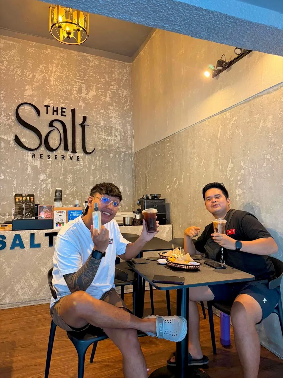 Guests at The Salt Reserve with the wall logo behind them