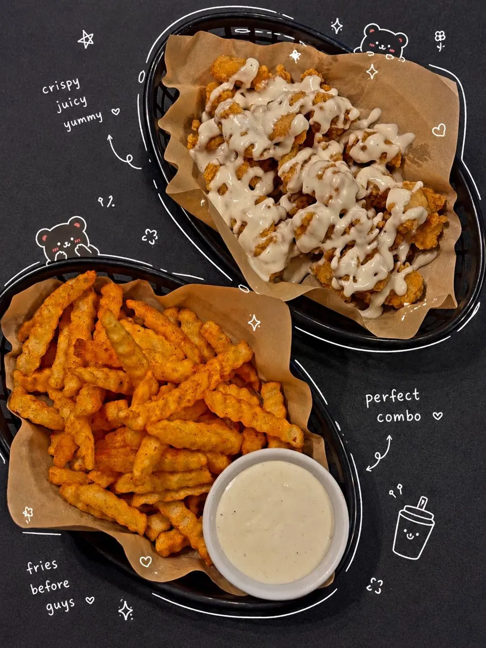 Crispy chicken poppers and seasoned fries in wire baskets